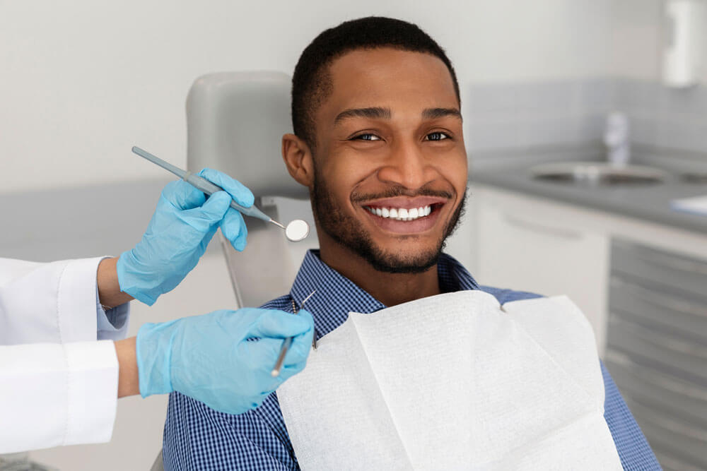 Smiling young male during dental treatment