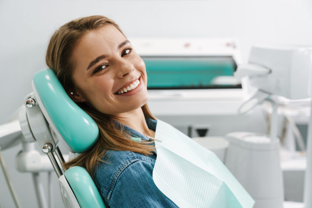 A woman smiling in a dentist office