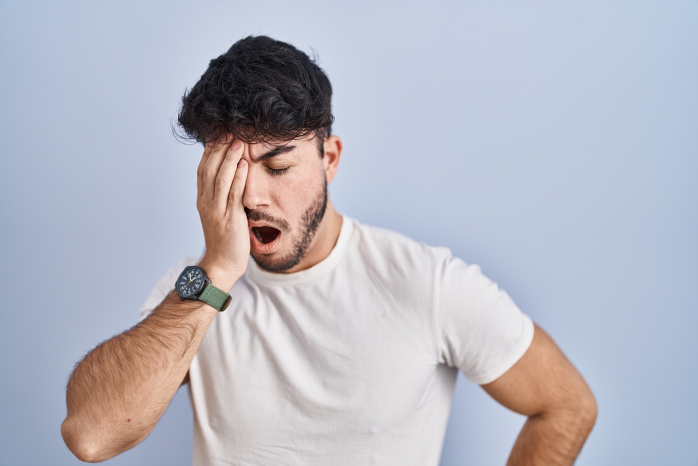 Man yawning due to lack of sleep possible caused by Sleep Apnea