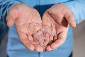 The,Dentist,Doctor,Holds,Transparent,Aligners,In,His,Hands